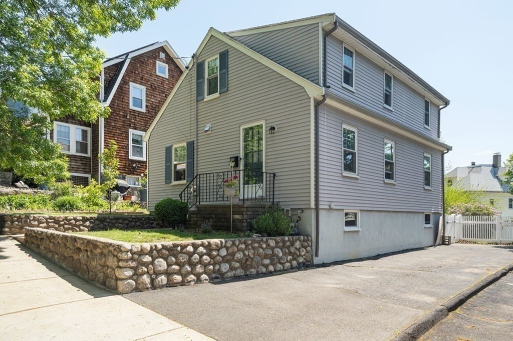 a front view of a house with garden