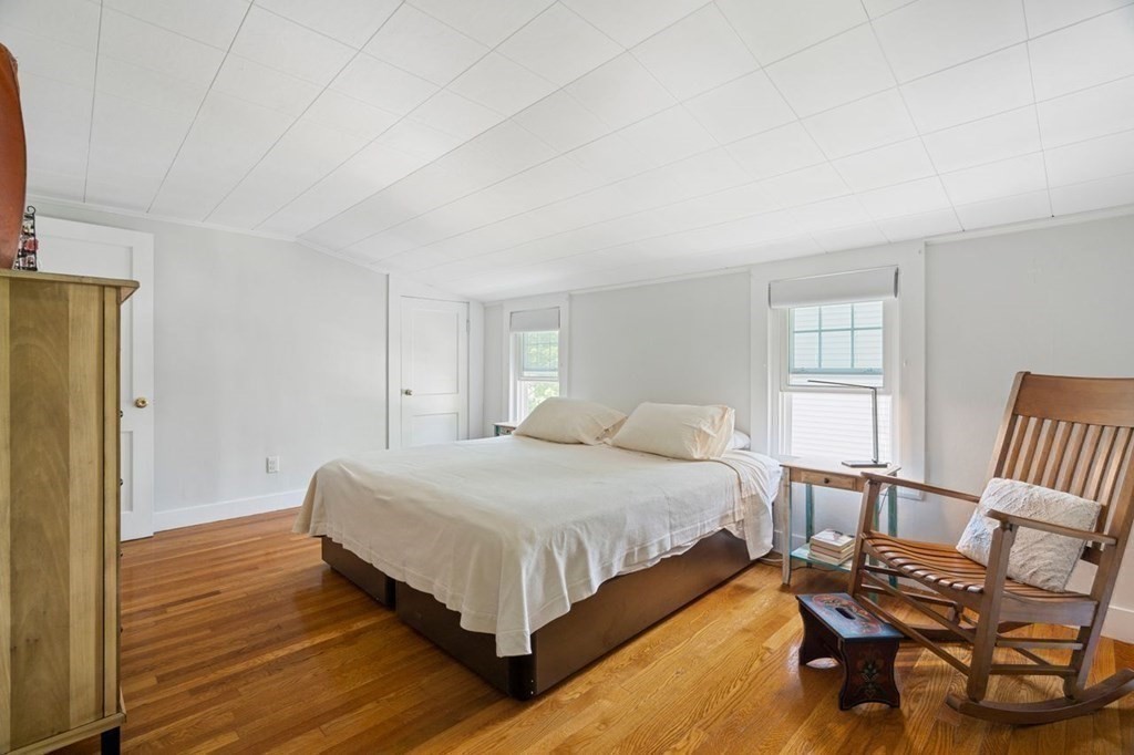 11 Sunset Road Arlington, MA 02474 - Photo 11 of 27 a bedroom with a bed a table and chair
