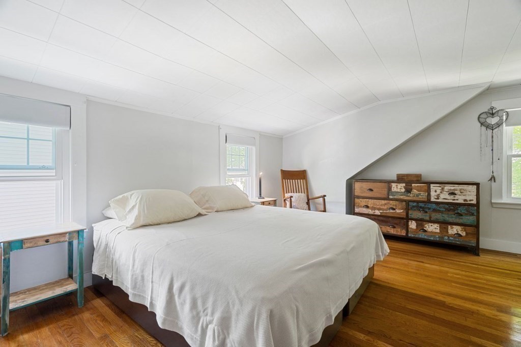 11 Sunset Road Arlington, MA 02474 - Photo 12 of 27 a bedroom with a bed and a flat tv screen on dresser