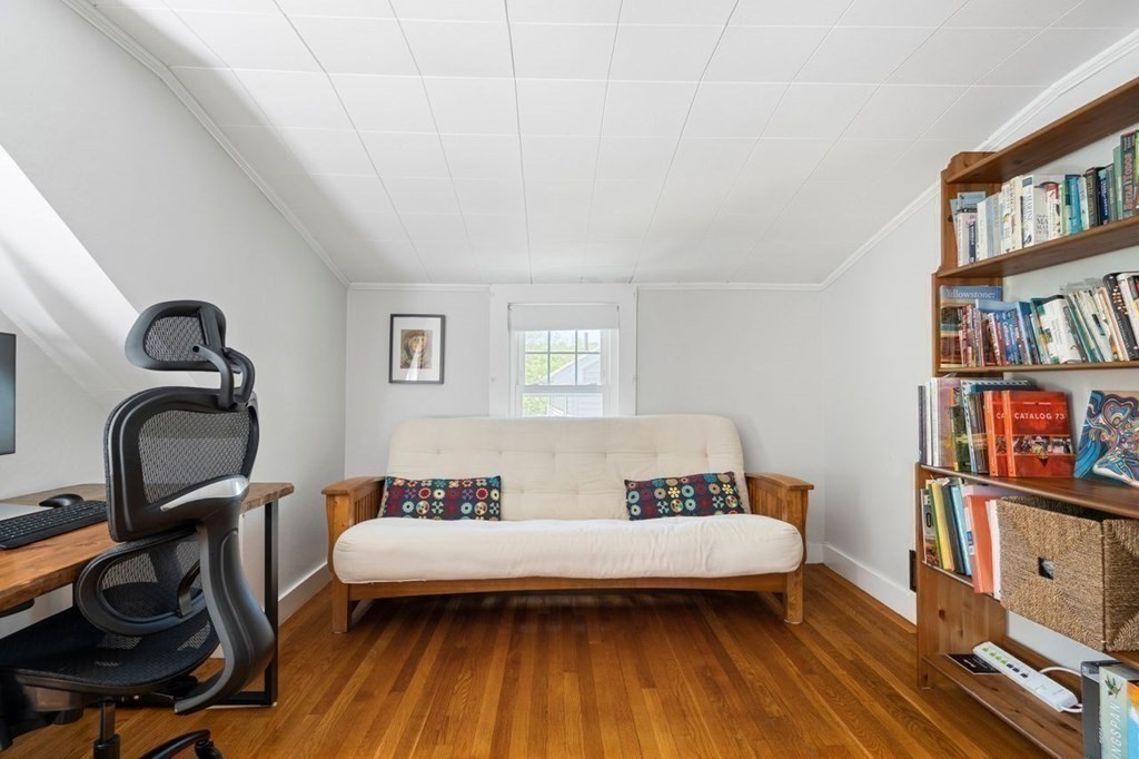 11 Sunset Road Arlington, MA 02474 - Photo 14 of 27 a bedroom with furniture and a book shelf