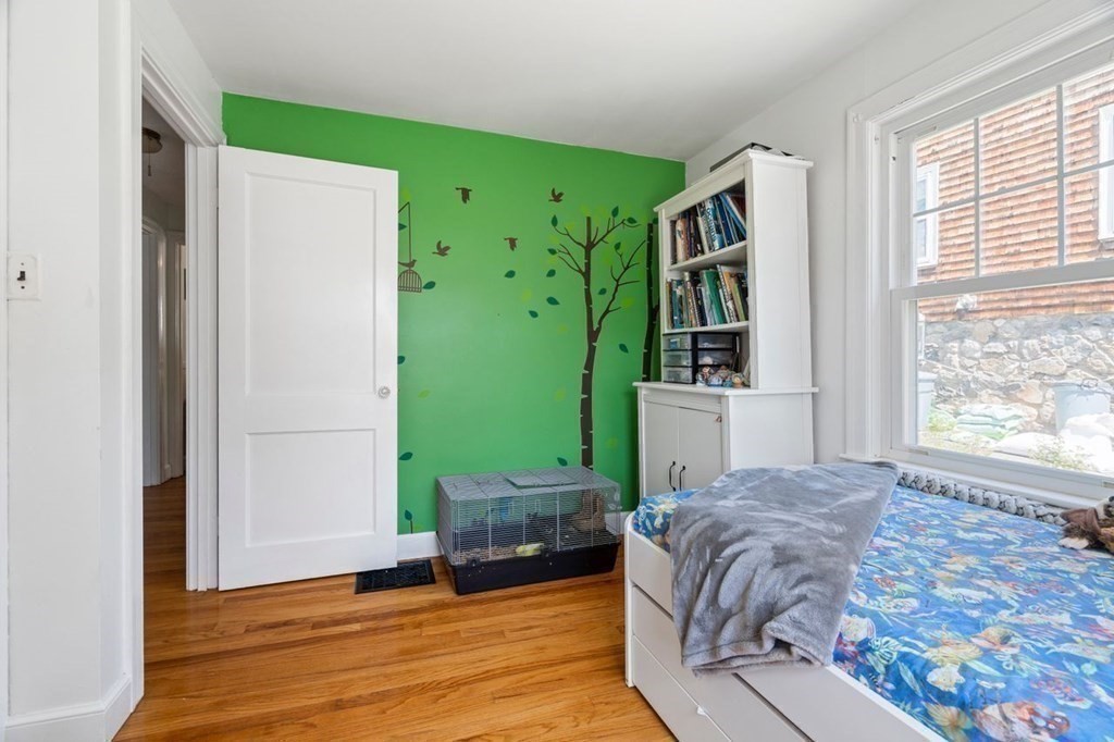 11 Sunset Road Arlington, MA 02474 - Photo 17 of 27 a bedroom with a bed windows and a mirror