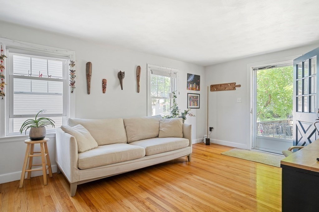 11 Sunset Road Arlington, MA 02474 - Photo 2 of 27 a living room with furniture and a large window