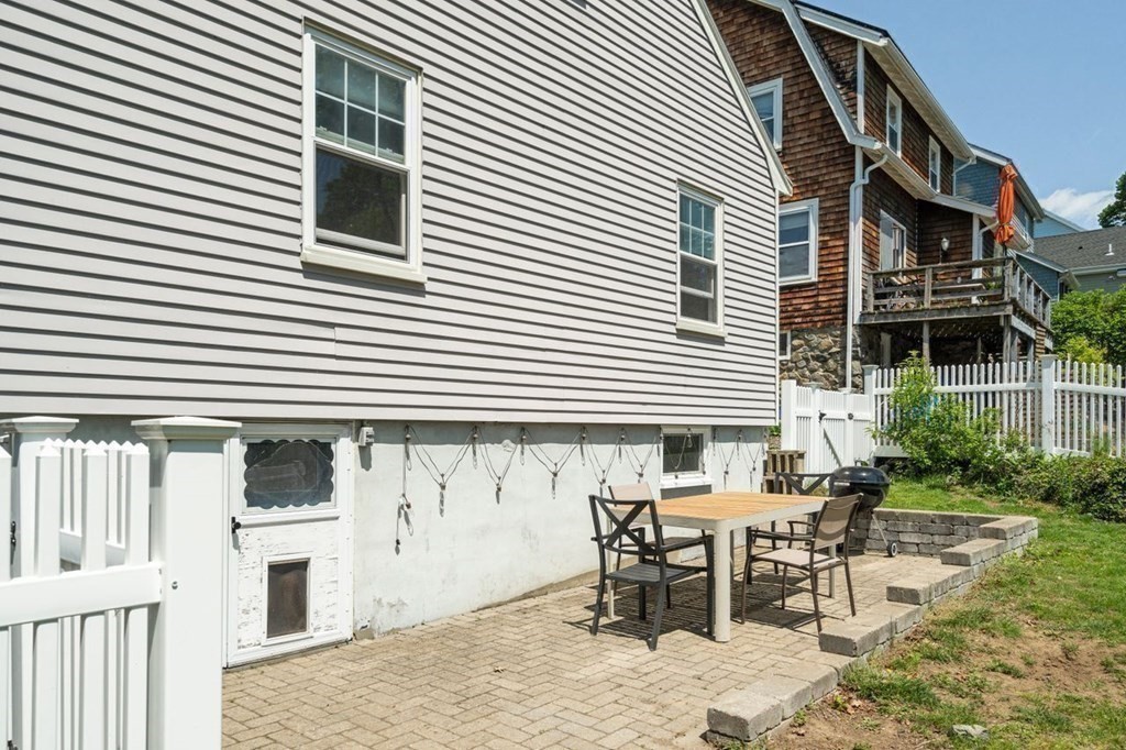 11 Sunset Road Arlington, MA 02474 - Photo 25 of 27 a view of a house with wooden deck and furniture
