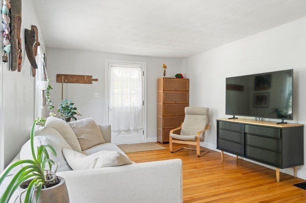 11 Sunset Road Arlington, MA 02474 - Photo 3 of 27 a living room with furniture and a flat screen tv