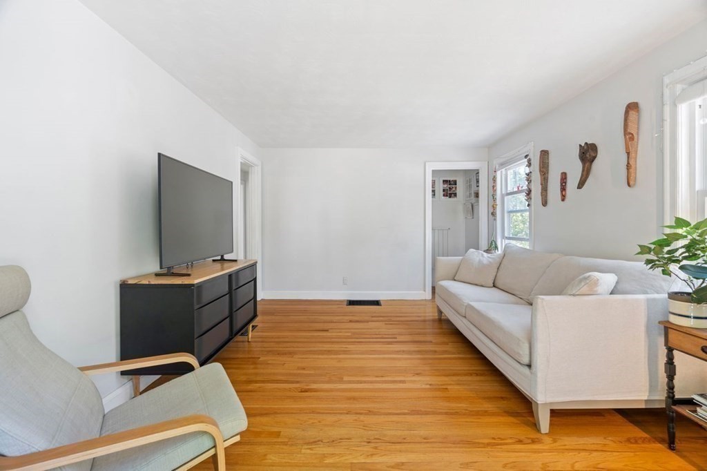 11 Sunset Road Arlington, MA 02474 - Photo 4 of 27 a living room with furniture and a flat screen tv