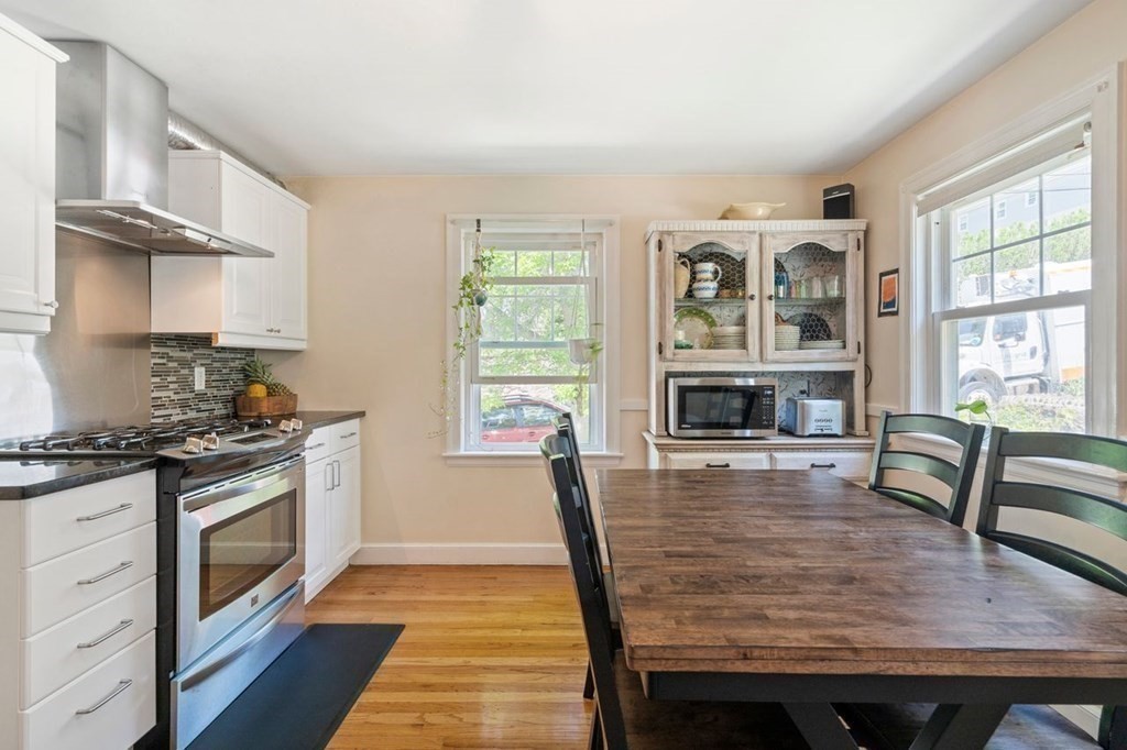 11 Sunset Road Arlington, MA 02474 - Photo 5 of 27 a kitchen with granite countertop wooden floor and a stove top oven