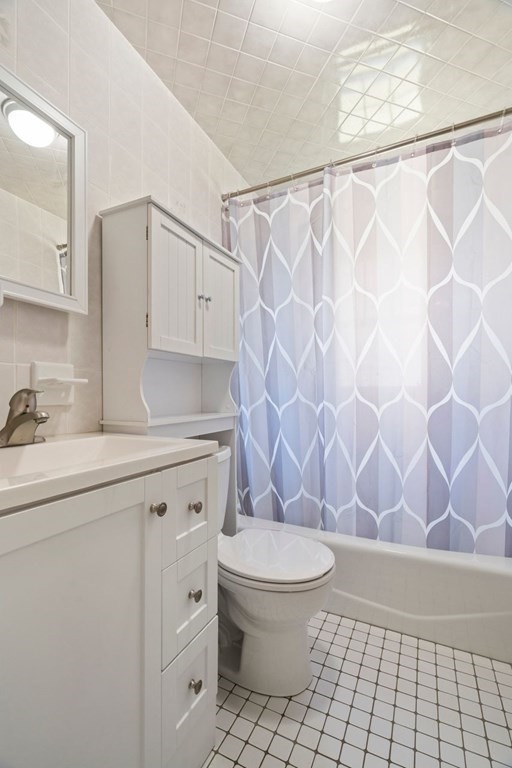 11 Sunset Road Arlington, MA 02474 - Photo 10 of 27 a bathroom with a granite countertop sink a toilet and a shower