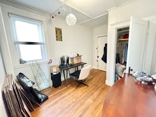 a view of a living room with furniture and wooden floor