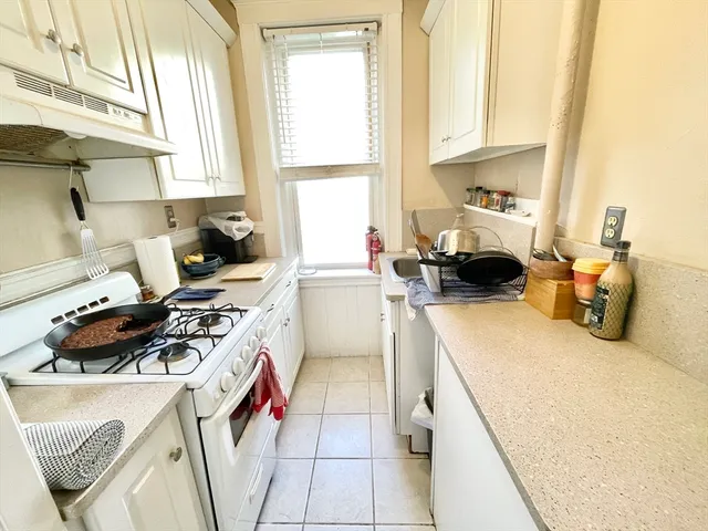 a kitchen with a stove a sink and a refrigerator