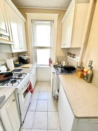 a kitchen with a sink a stove and a refrigerator