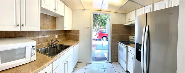 a kitchen with a refrigerator a stove a washer and dryer