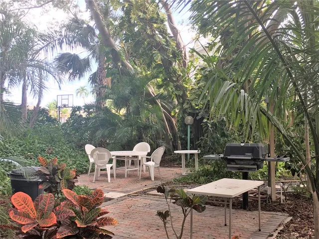 a view of a chairs and tables in the back yard of the house