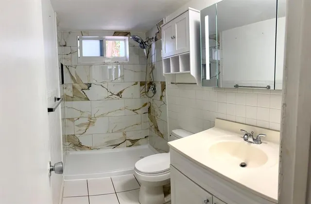 a bathroom with a sink toilet and shower