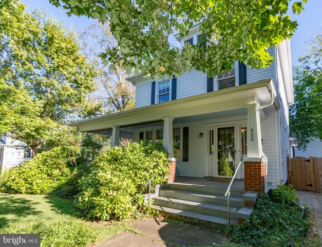 a backyard of a house with barbeque oven table and chairs