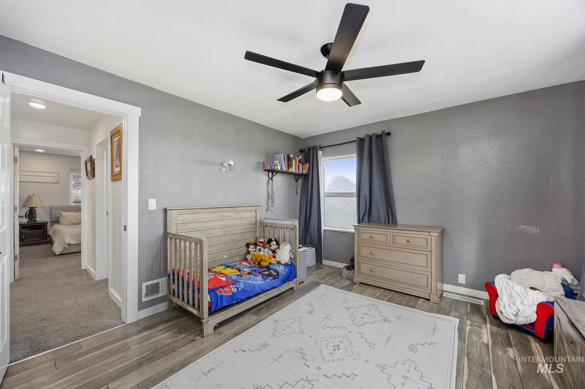 128 South 100 East Rupert, ID 83350 - Photo 20 of 44 Bedroom with wood finished floors and ceiling fan
