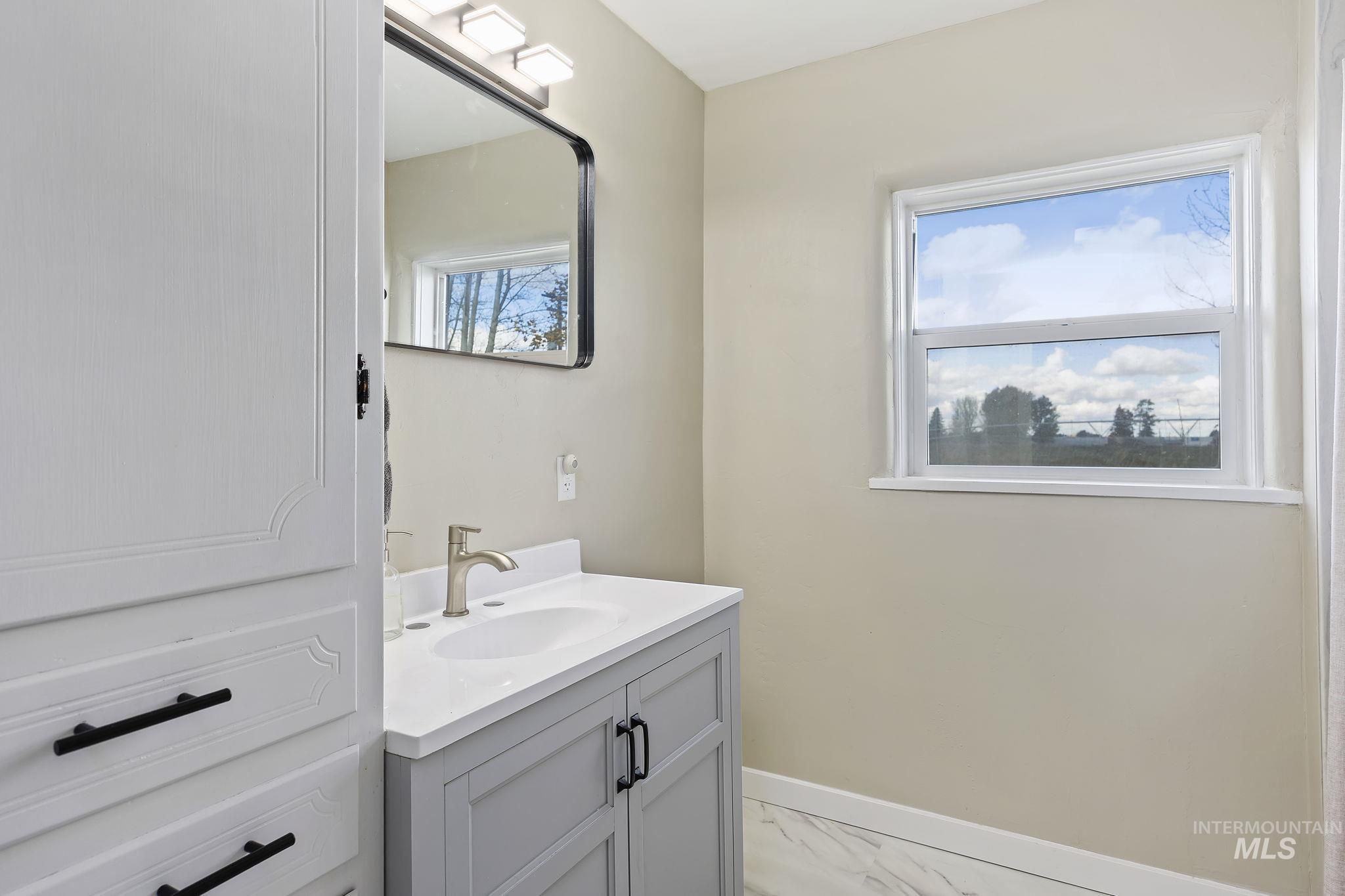128 South 100 East Rupert, ID 83350 - Photo 21 of 44 Bathroom featuring vanity and light marble finish flooring