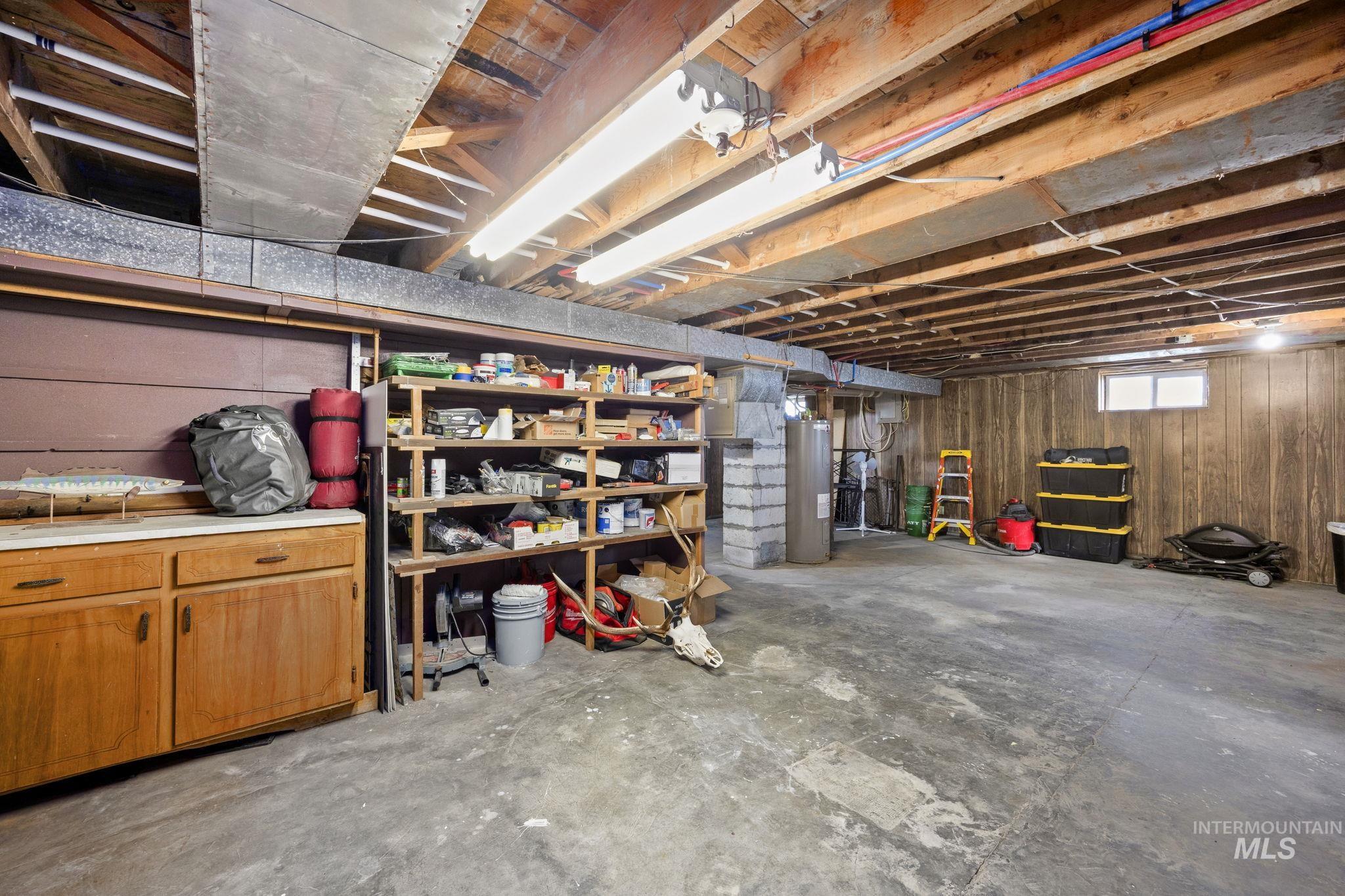 128 South 100 East Rupert, ID 83350 - Photo 27 of 44 Basement featuring wood walls and water heater