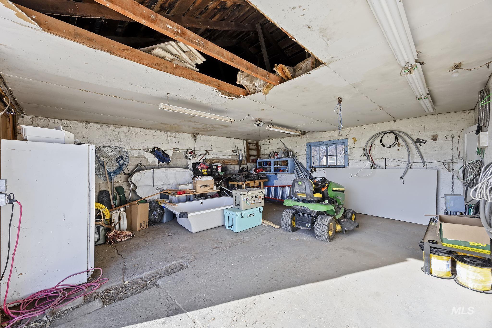 128 South 100 East Rupert, ID 83350 - Photo 32 of 44 Garage with freestanding refrigerator and concrete block wall