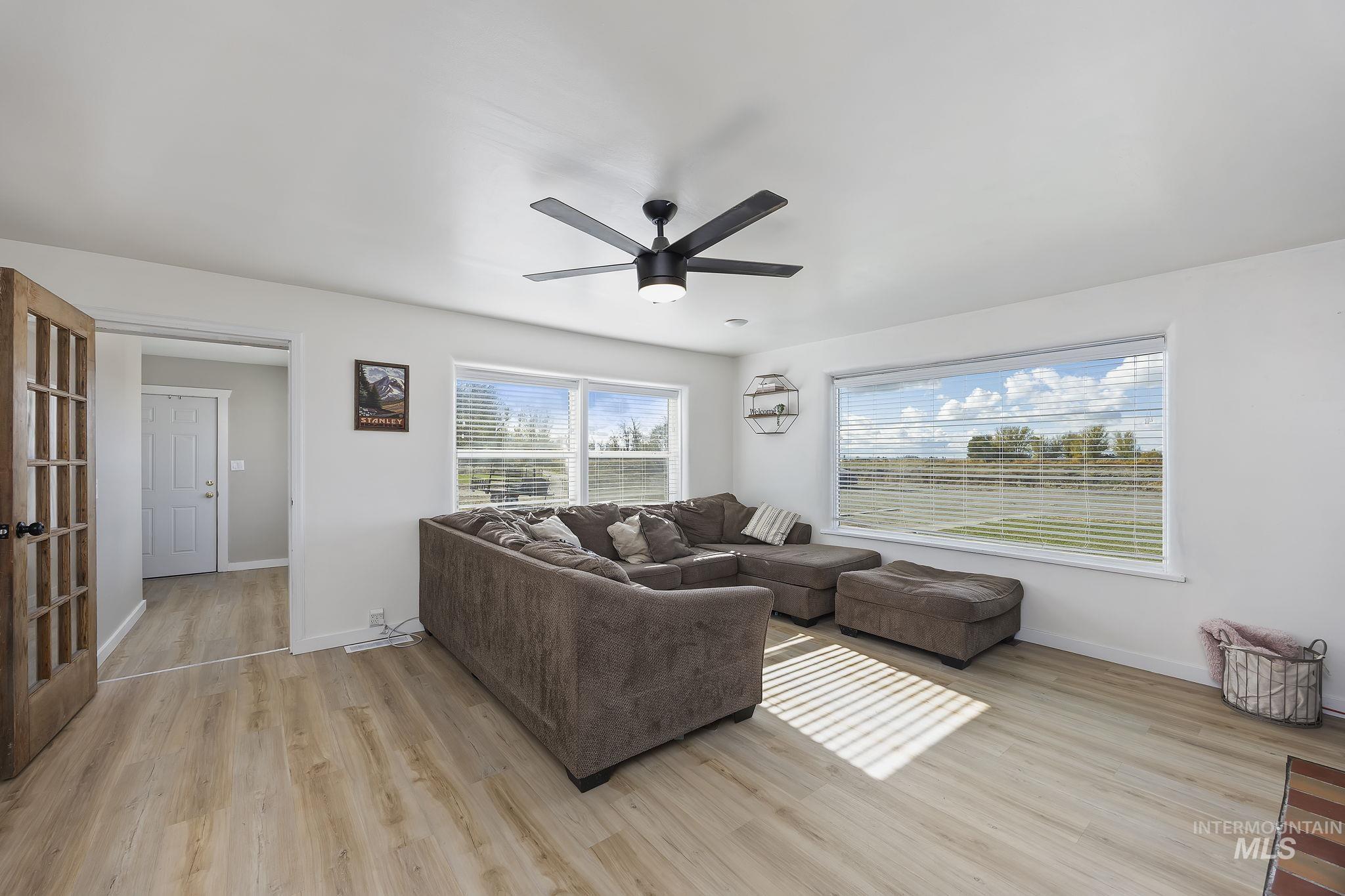 128 South 100 East Rupert, ID 83350 - Photo 7 of 44 Living area featuring light wood-style flooring and ceiling fan