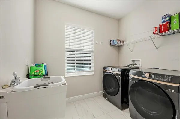 a spacious bathroom with a granite countertop sink a mirror and a bathtub