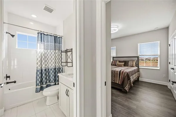 a bedroom with a bed and a couch