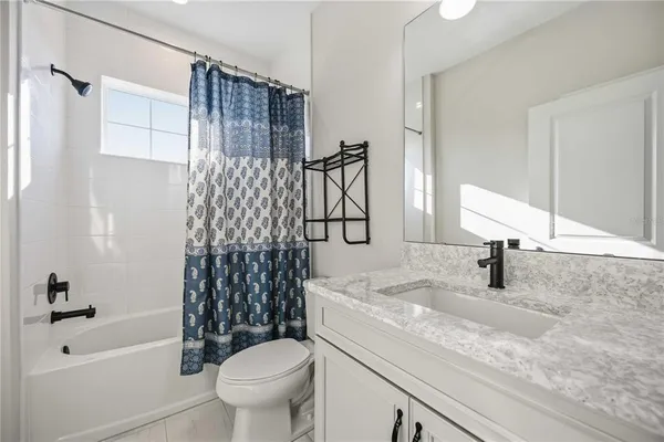 a spacious bathroom with a tub sink shower and a mirror
