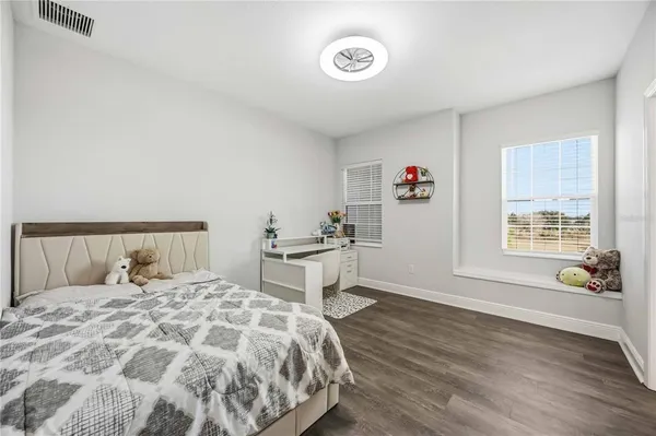 a dining room with furniture and a floor to ceiling window