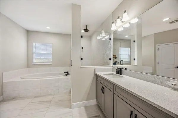an aerial view of residential houses with outdoor space and ocean view