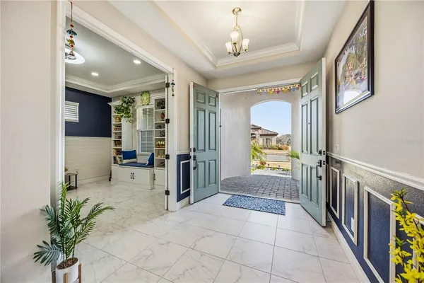 a living room with furniture and a floor to ceiling window
