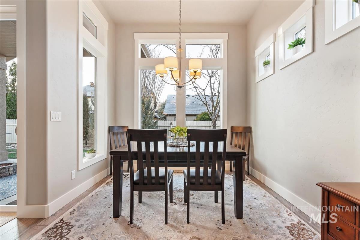 1447 West Arch Rock Street Meridian, ID 83646 - Photo 11 of 43 Dining room featuring a chandelier and light wood-type flooring