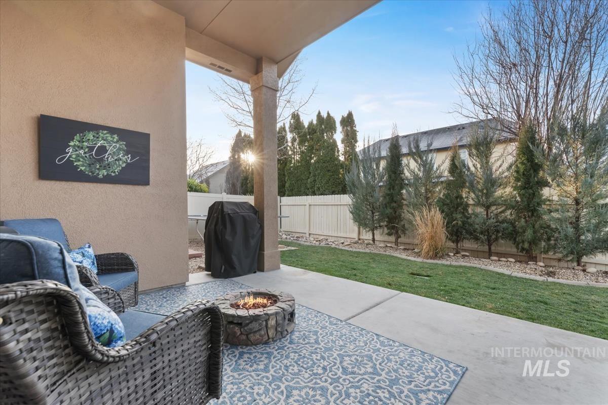 1447 West Arch Rock Street Meridian, ID 83646 - Photo 33 of 43 Fenced backyard with a patio area, an outdoor fire pit, and grilling area
