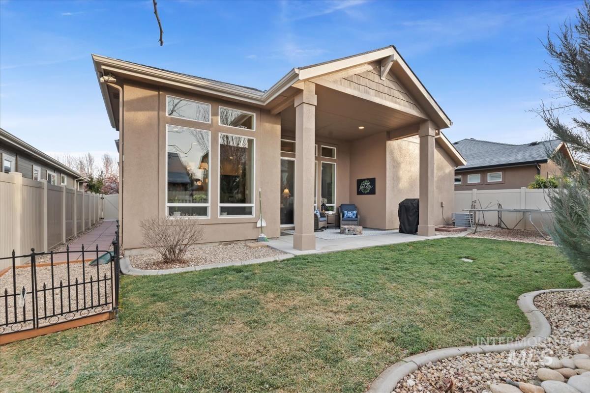 1447 West Arch Rock Street Meridian, ID 83646 - Photo 36 of 43 Back of property with a fenced backyard, stucco siding, a patio area, and a gate