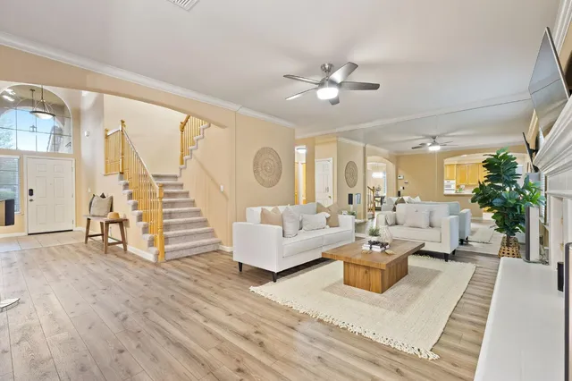 a living room with furniture a fireplace and a flat screen tv