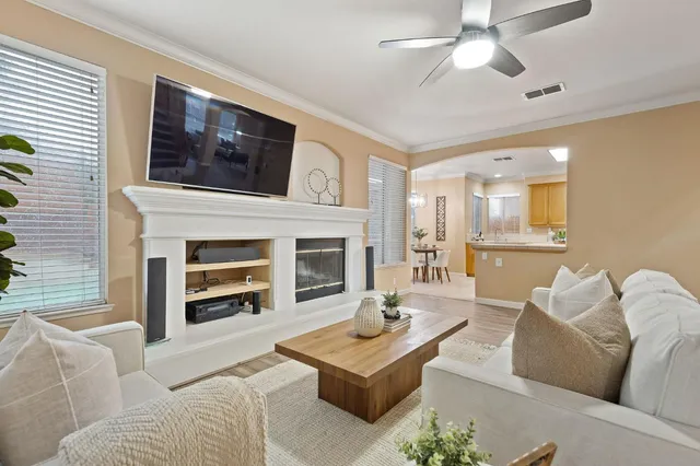 a dining room with furniture a chandelier and wooden floor