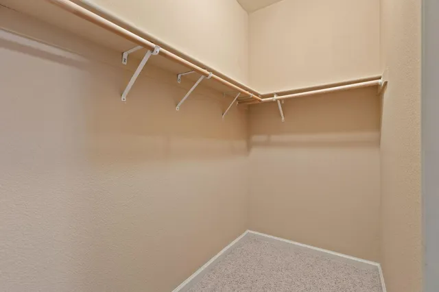 an empty room with a ceiling fan and a window