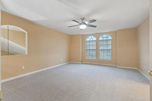 a bathroom with a tub a sink and a window