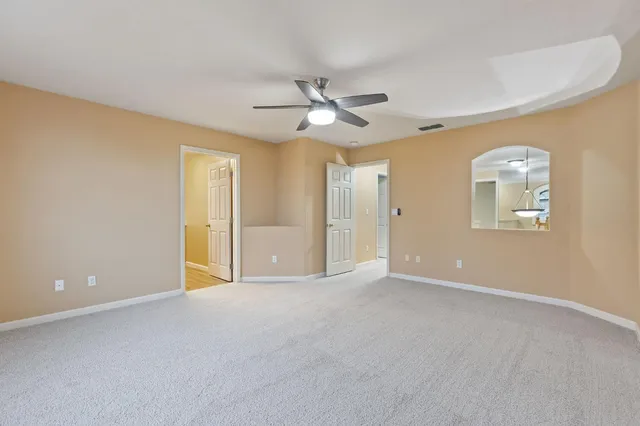 a spacious bathroom with a granite countertop sink a mirror and a shower