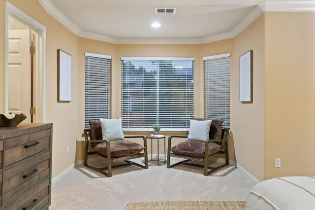 a view of a house with backyard and sitting area