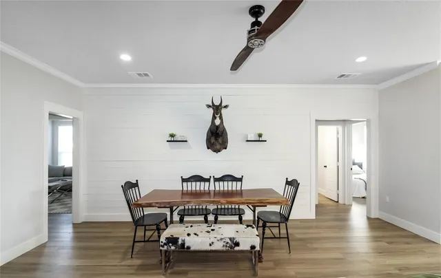a view of a dining room with furniture and wooden floor
