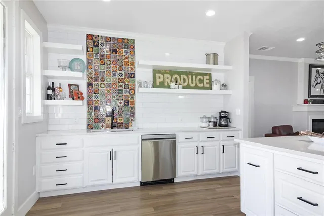a kitchen with stainless steel appliances a stove and cabinets
