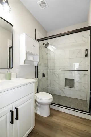 a bathroom with a sink toilet and shower