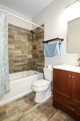a bathroom with a toilet and a bathtub