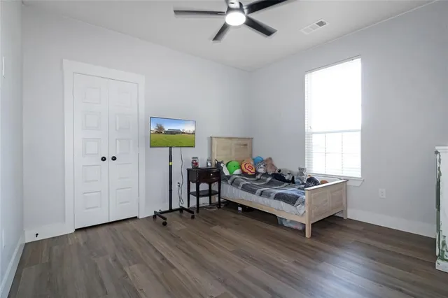 a living room with hard wood floors and a window