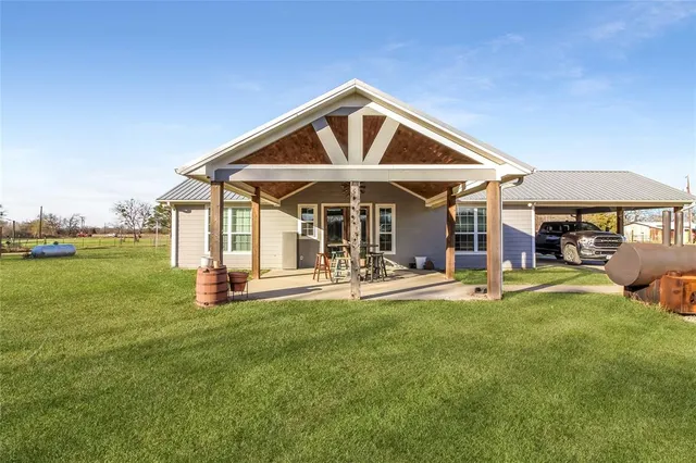 a front view of a house with swimming pool having outdoor seating