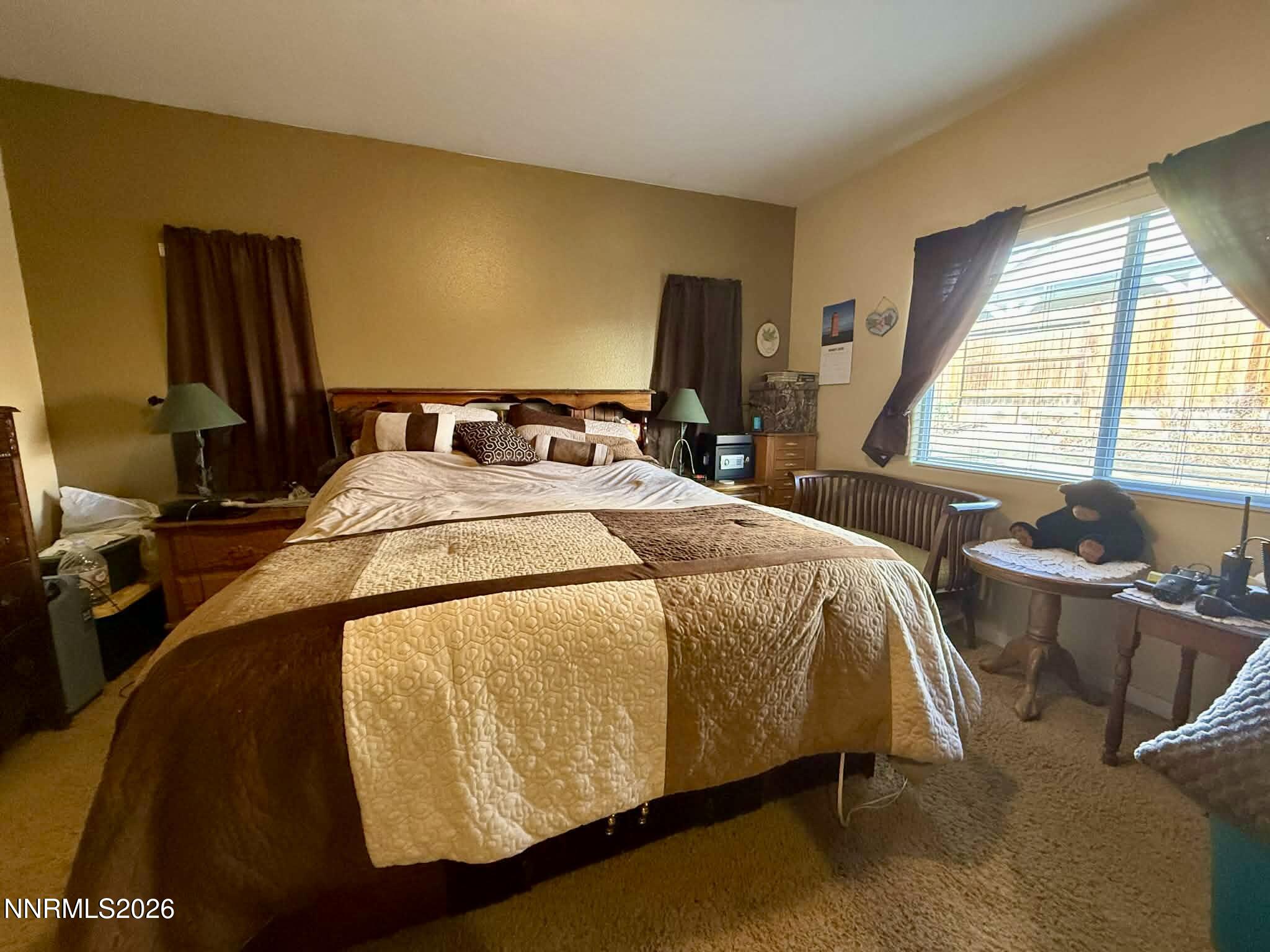 672 Cardinal Circle Fernley, NV 89408 - Photo 14 of 15 a bed sitting in a bedroom next to a window