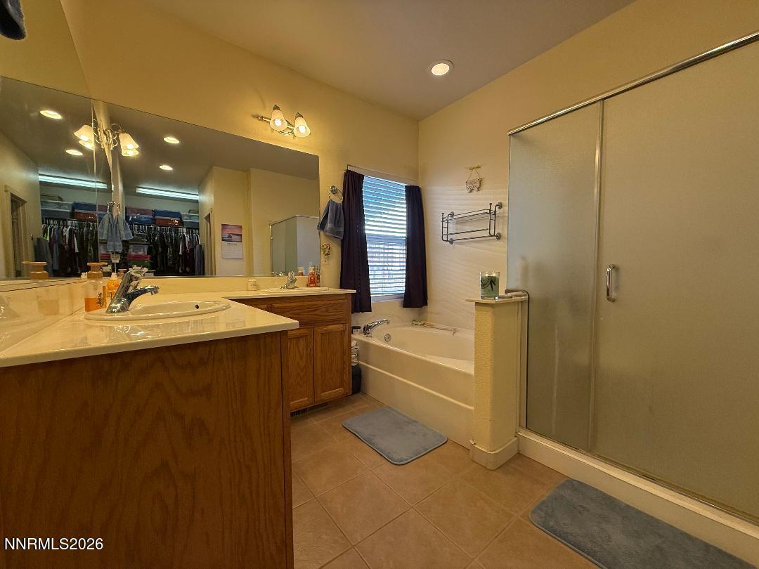 672 Cardinal Circle Fernley, NV 89408 - Photo 15 of 15 a bathroom with a tub a sink and a shower