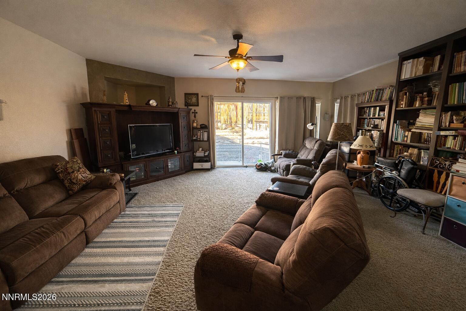 672 Cardinal Circle Fernley, NV 89408 - Photo 7 of 15 a living room with furniture a flat screen tv and a fireplace