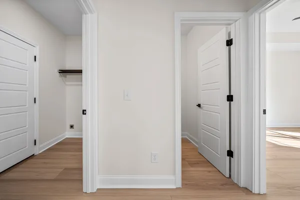 a view of a big room with wooden floor and a ceiling fan