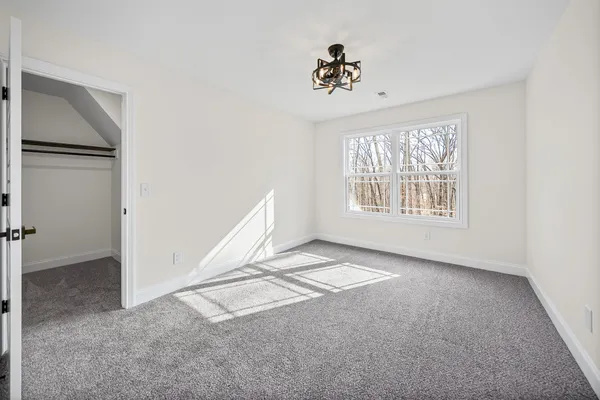 a spacious bathroom with a shower sink and mirror
