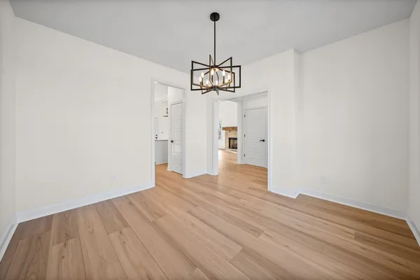 a view of a livingroom with fireplace wooden floor and windows